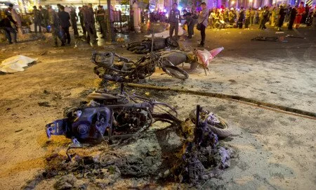 Wreckage of motorcycles are seen as security forces and emergency workers gather at the scene of a blast in central Bangkok August 17, 2015. A bomb on a motorcycle exploded on Monday just outside a Hindu shrine in the centre of the Thai capital, killing at least 12 people, police and a rescue worker said. REUTERS/Athit Perawongmetha TPX IMAGES OF THE DAY