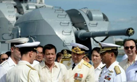 Philippine President Rodrigo Duterte (3rd L) talks to Russia's Rear Admiral Eduard Mikhailov (4th R) at the anti-submarine navy ship Admiral Tributs at the south pier in Metro Manila, Philippines January 6, 2017. REUTERS/Noel Celis/Pool