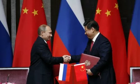 Russia's President Vladimir Putin, left, and China's President Xi Jinping shake hands after signing an agreement during a bilateral meeting at the Xijiao State Guesthouse ahead of the fourth Conference on Interaction and Confidence Building Measures in Asia (CICA) summit, in Shanghai, China Tuesday, May 20, 2014. (AP Photo/Carlos Barria, Pool)