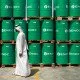 A visitor passes ENOC-branded oil barrels stored at the Emirates National Oil Co. lubricants and grease manufacturing plant in Fujairah, United Arab Emirates, on Monday, March 12, 2012. ENOC, as Dubai's government-owned refiner is known, will expand the plant's capacity to 250,000 tons a year by 2014, it said. Photographer: Gabriela Maj/Bloomberg